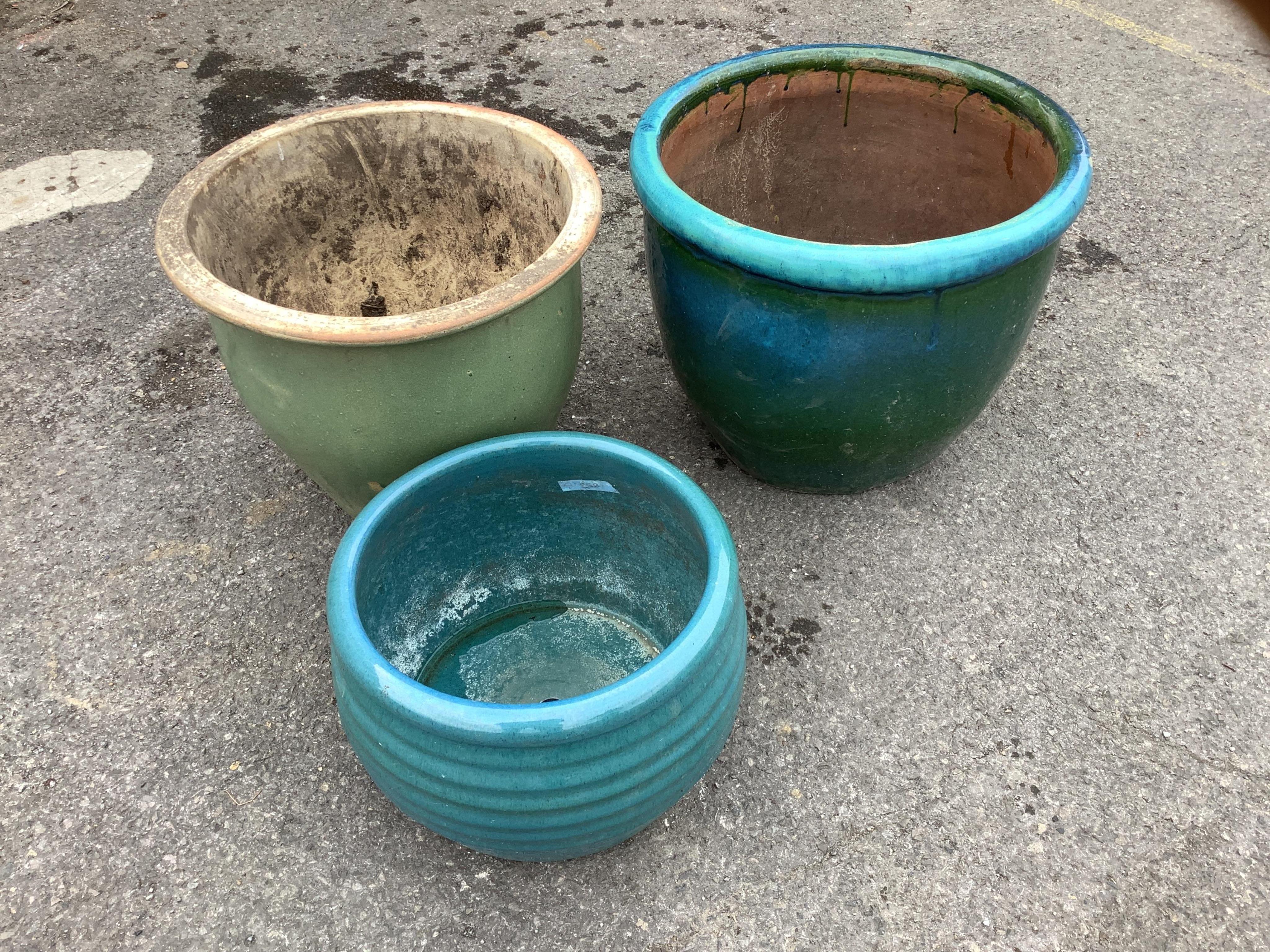 Three circular turquoise glazed earthenware garden planters, largest diameter 50cm, height 42cm. Condition - fair